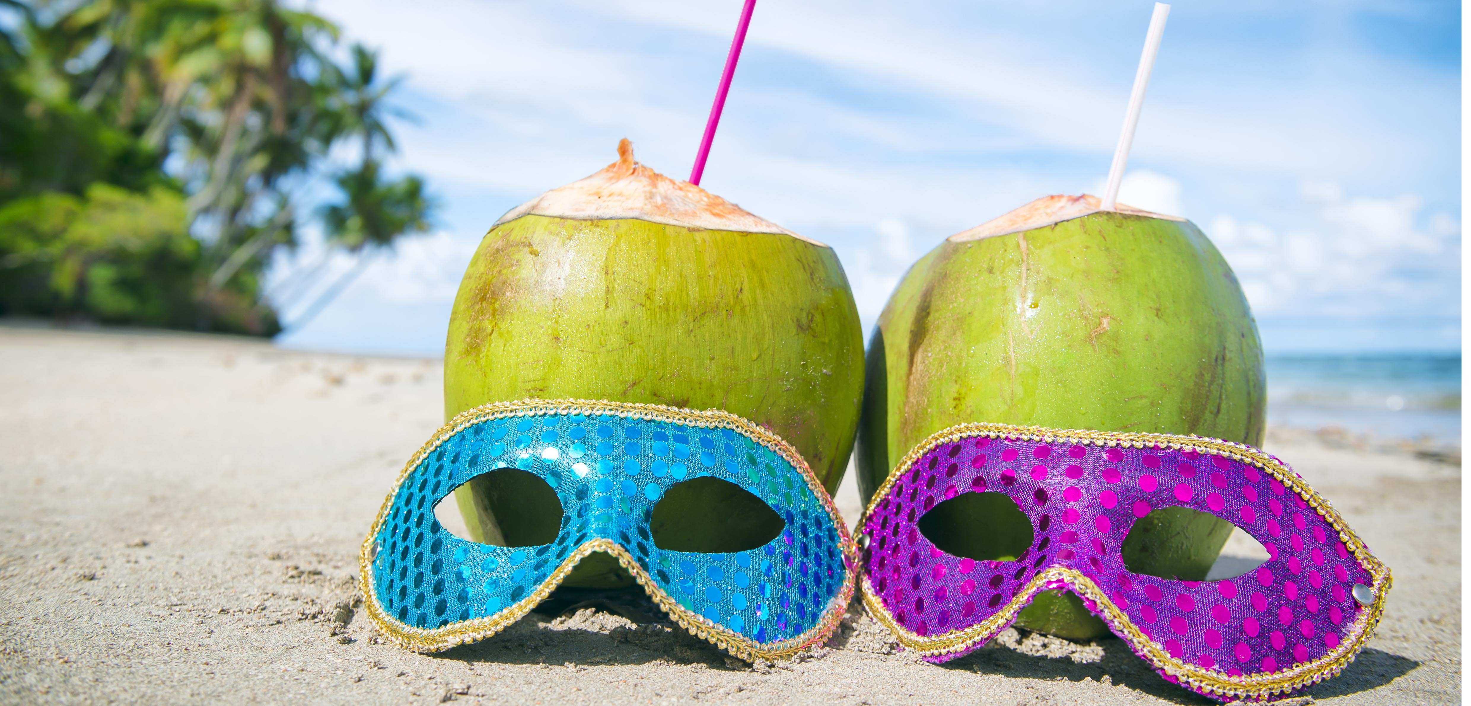 Colorful sequined carnival masks and fresh green coconut drinks